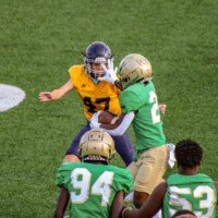 Buford's Kylan Baker gives Marist the stiff arm. Photo by Alicia Payne.
