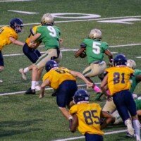 Justin Hawthorne runs the ball. Photo by Alicia Payne